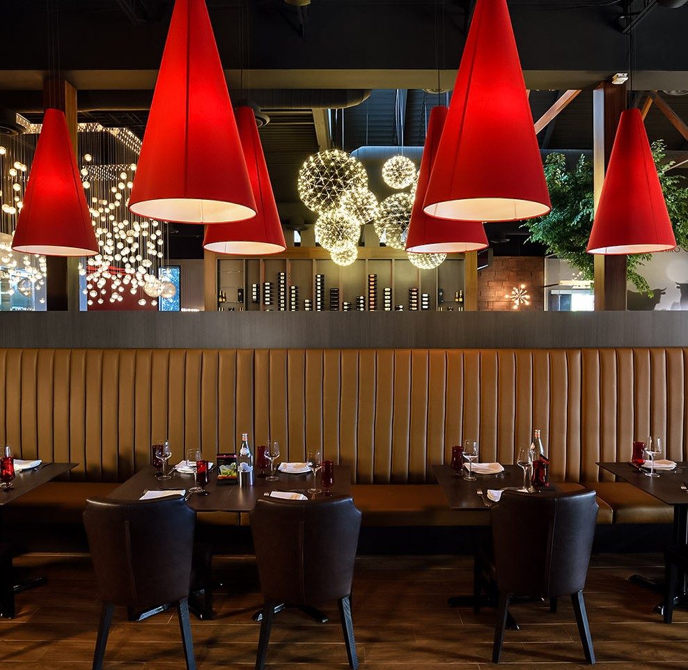 Booth seating under red pendants